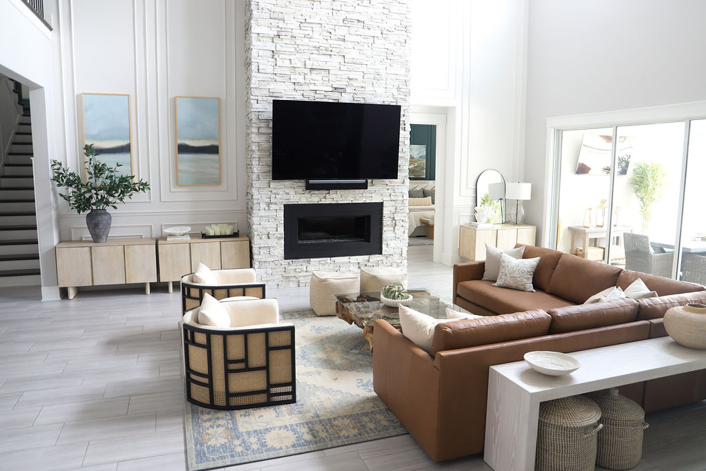 This space is now a beautifully decorated Modern Coastal living room complete with wall treatments, new furniture, and beautiful coastal decor pieces that catch the eye.