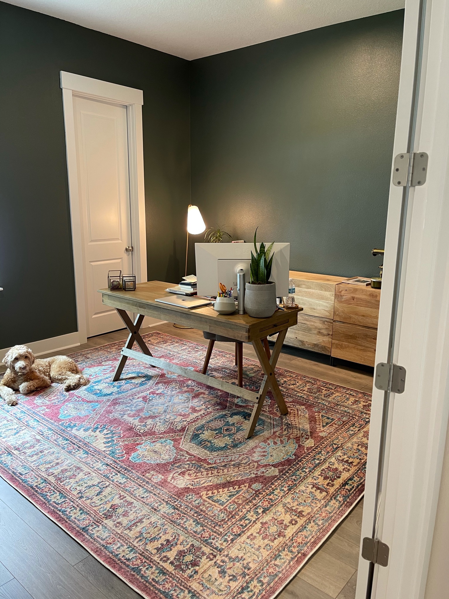 Welcome Home Styling designed this office space with dark green wall color. 