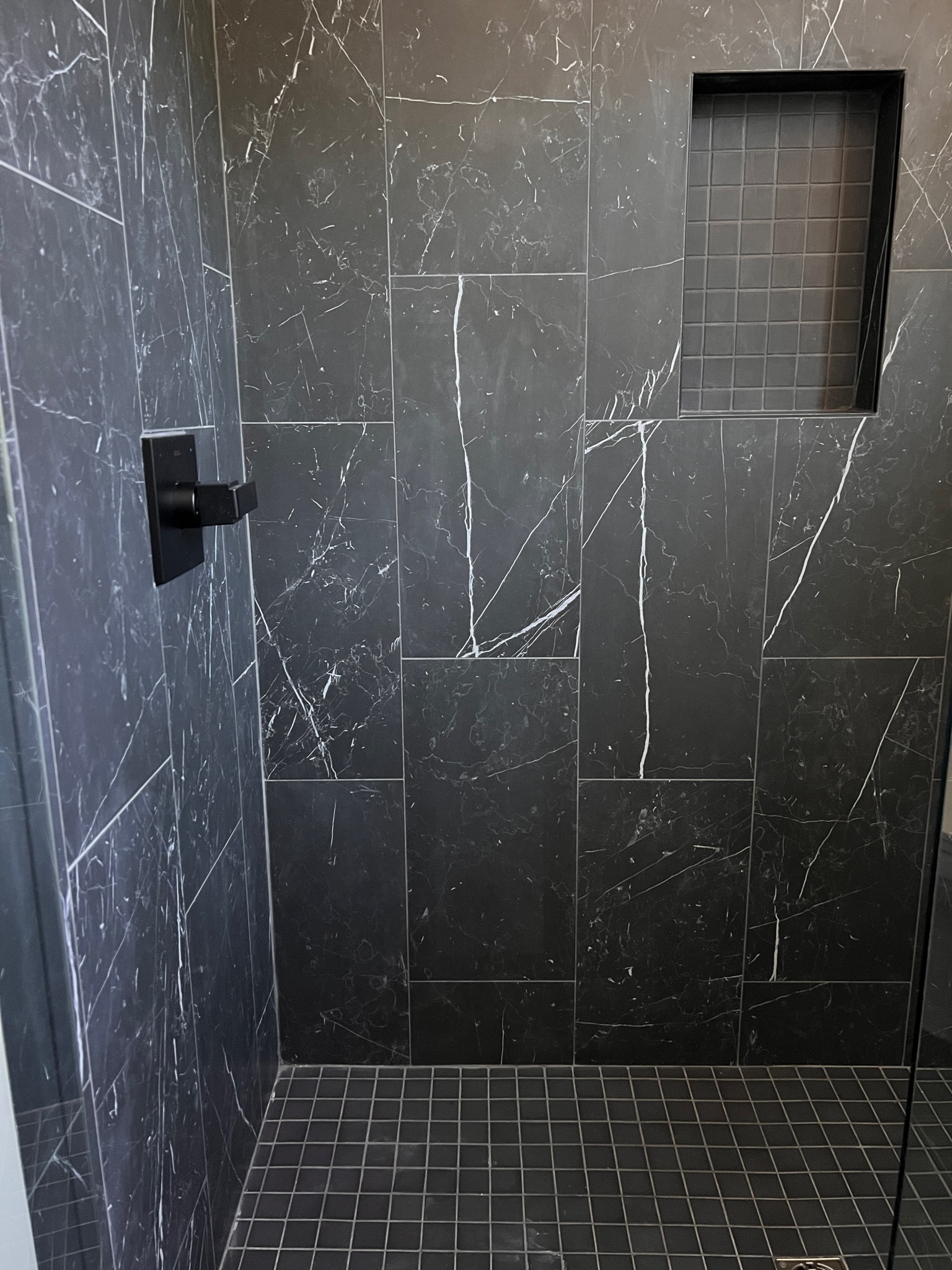 This stunning dark tile makes a statement in the master bathroom.