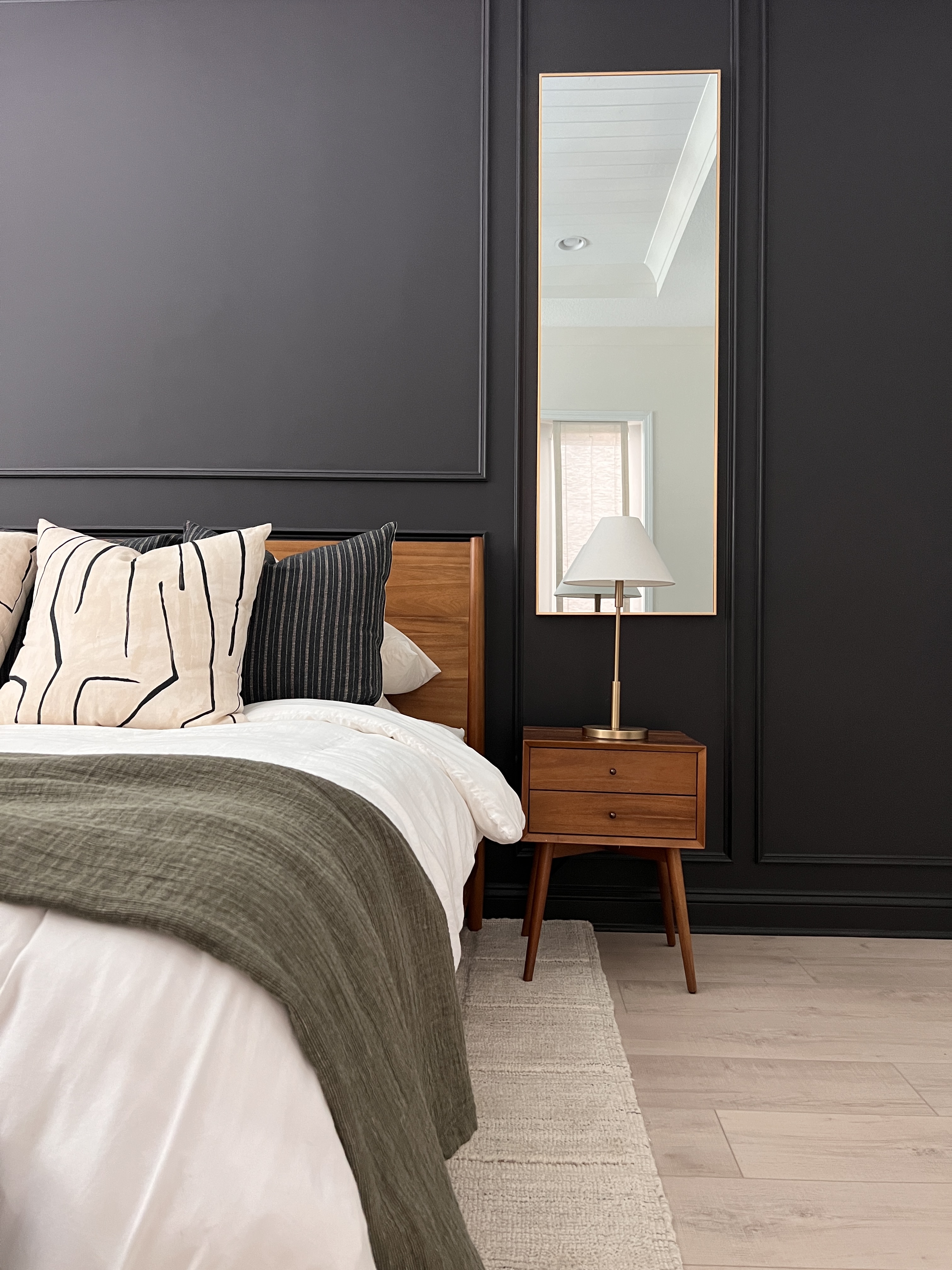 This moody bedroom accent wall was designed by Welcome Home Styling.