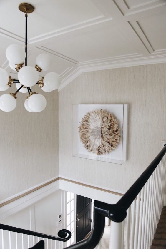 This ceiling treatment is painted the same color as the ceiling but creates a visually impactful hallway space.