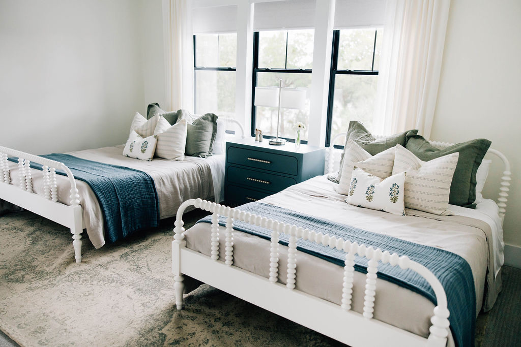 Welcome Home Styling brought this beautiful digital interior design to life for this cozy coastal-inspired twin bedroom utilizing a large area rug under the beds to make the room feel more cohesive.