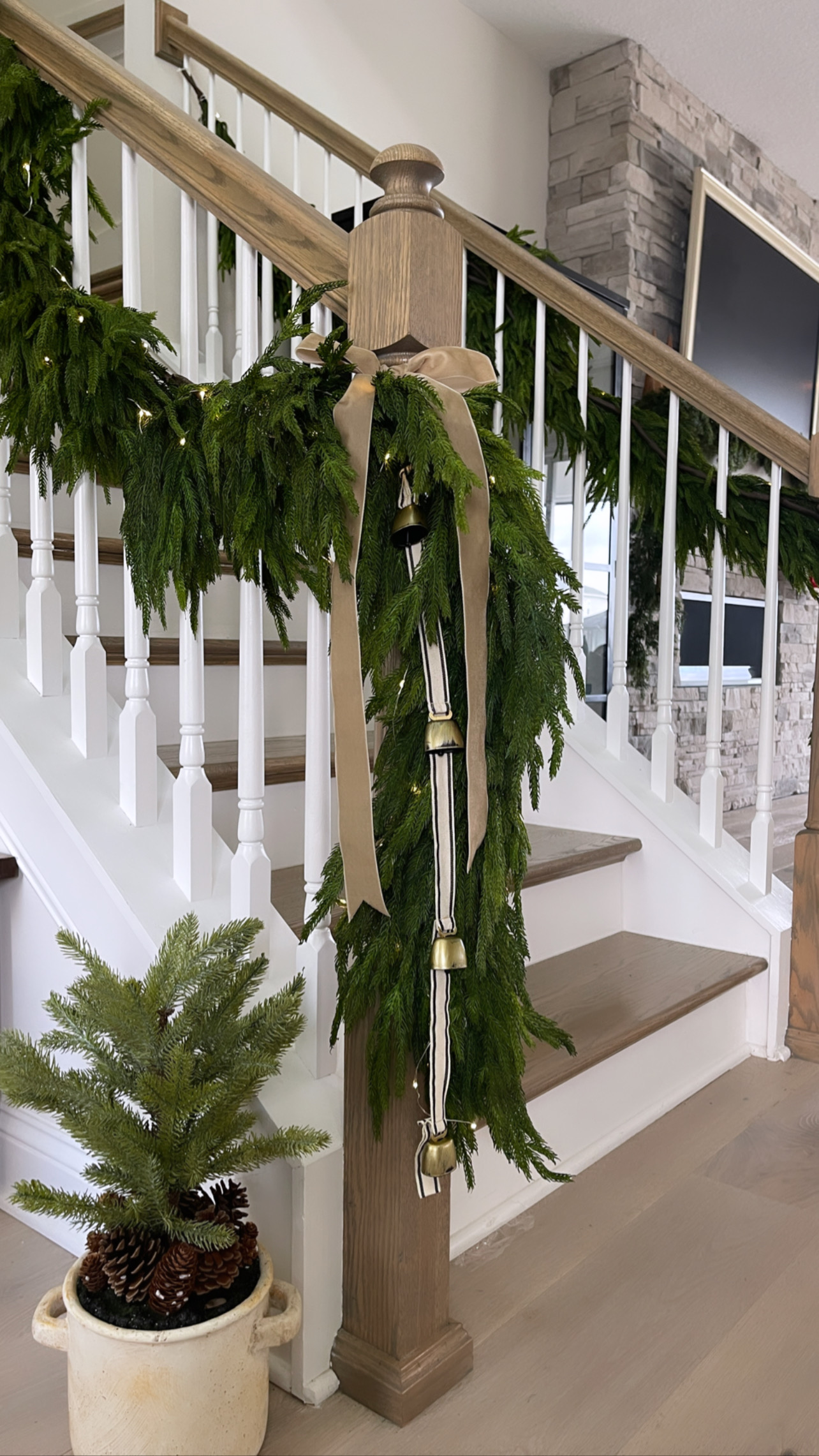 Winter greens and fairy lights add a festive holiday touch to this staircase banister. 