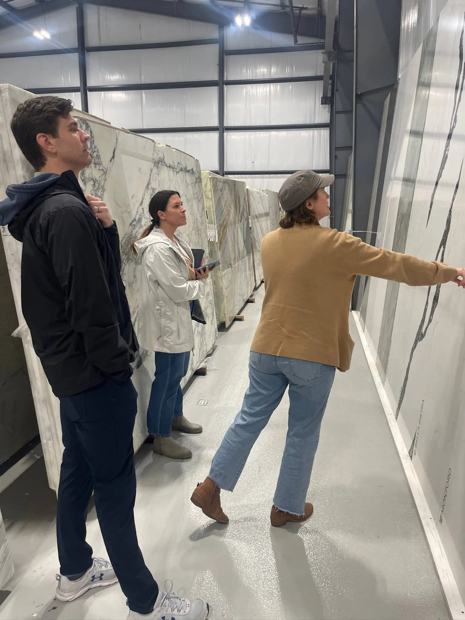 Jessica Woodward visits a granite shop with clients to help them select finishings for their home.