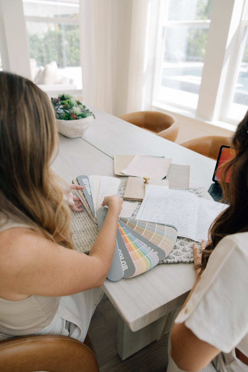 Interior Designer Jessica Woodward and Junior Interior Designer Shelly McDonald review design selecting for a new construction home.