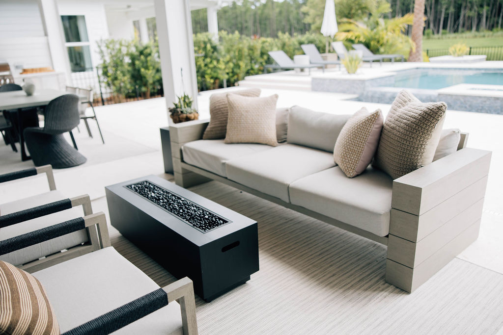 Modern furniture and a simple electric fire pit create a beautiful outdoor space.