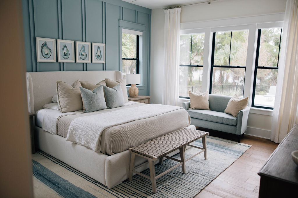 Coastal casual bedroom with a blue accent wall, soft finishes, and plush furniture.