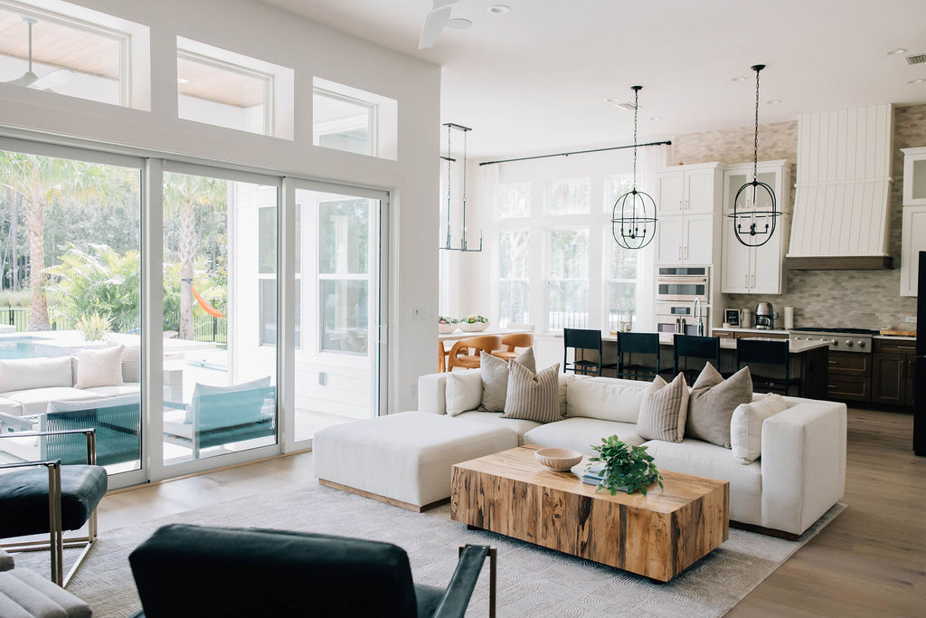 living room and kitchen area with custom finishes and ample natural light.