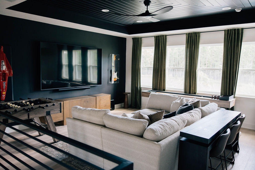 loft area with dark accent wall and painted ceiling to provide a media room feel without losing sophistication.