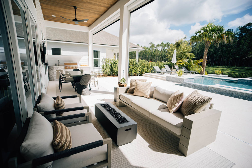 outdoor area with dining area, conversation space with firepit, and lounging area by the pool.