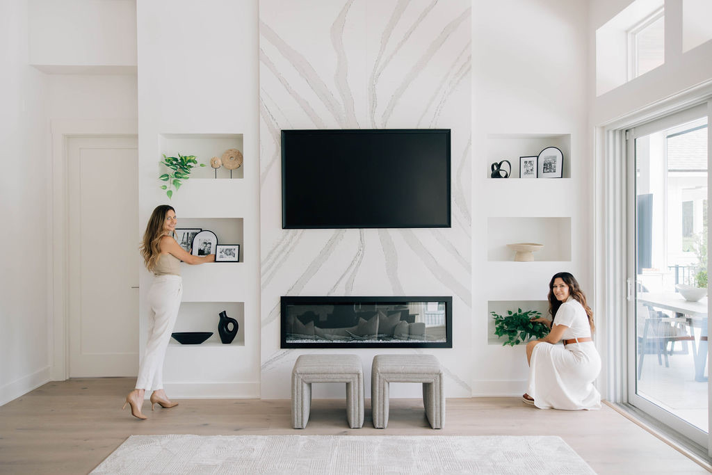 Welcome Home Styling team adding final details to custom built-ins.