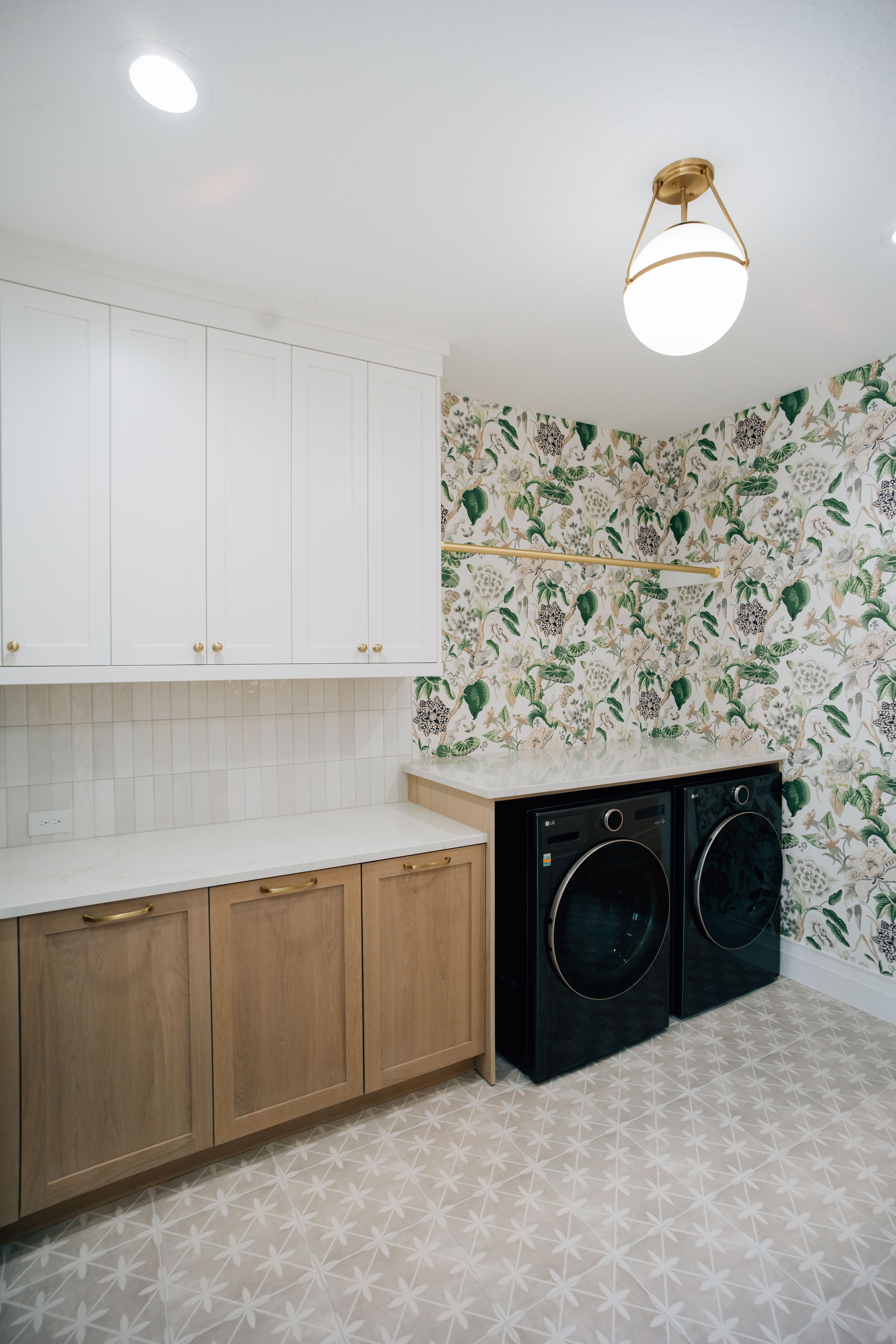 Fun and Functional Laundry Room The botanical wallpaper, patterned floor tile, and ample storage make this laundry room fun and functional.