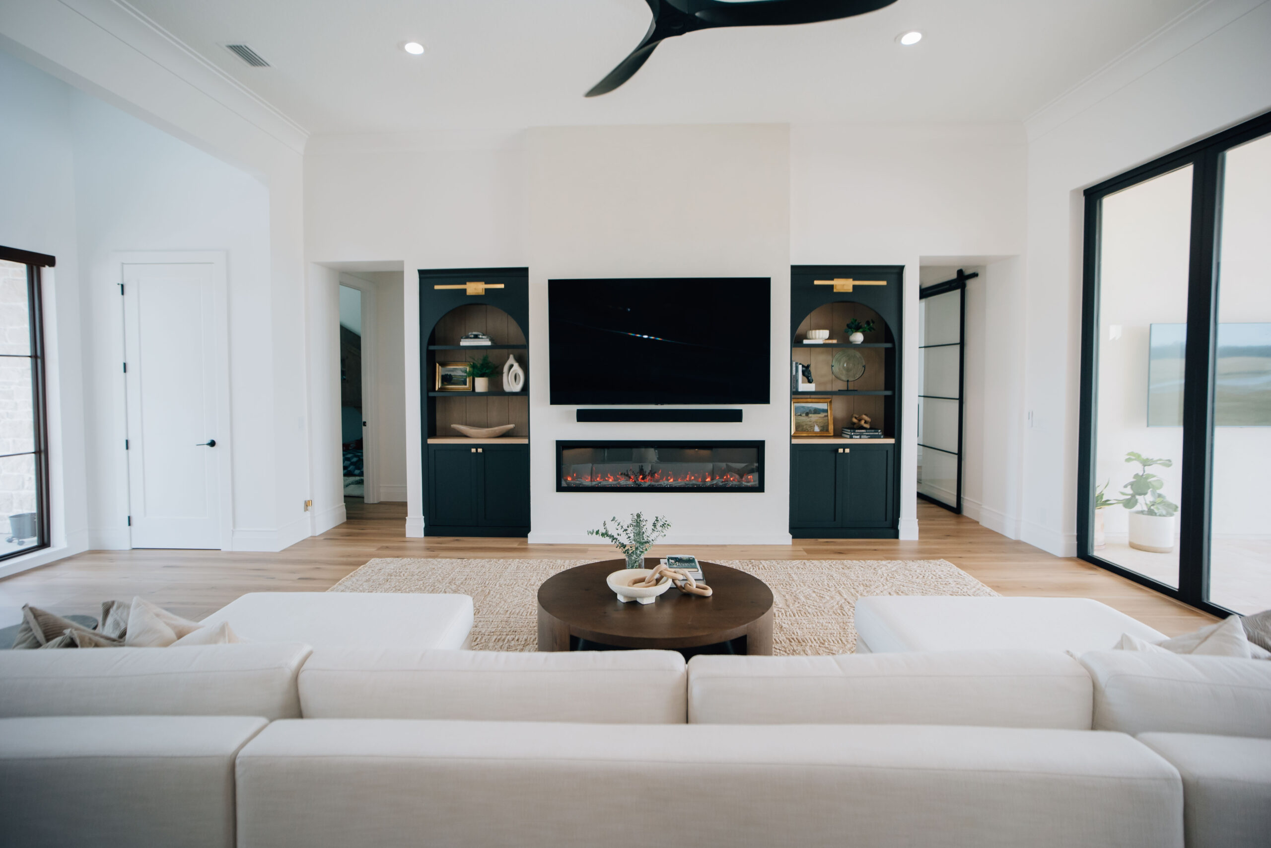 Luxurious Family Room Interior design
refresh overview image of the living room, showing the custom built-ins, electric fireplace, and comfortable sectional.