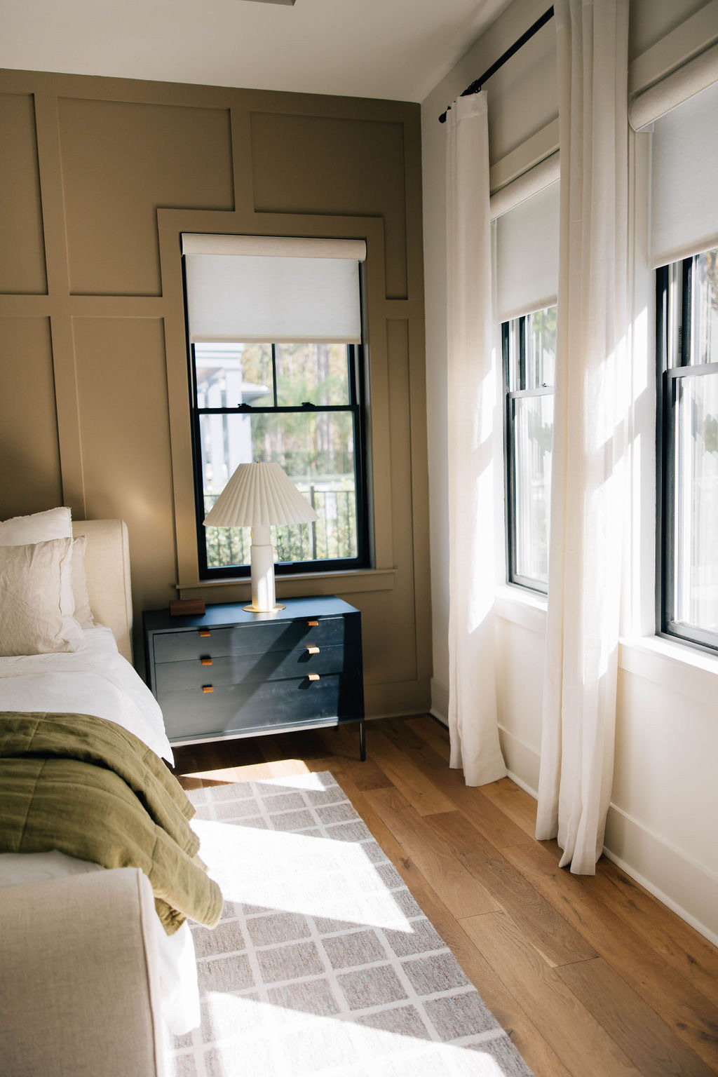 Warm and inviting guest room design featuring neutral tones, layered textures, and soft natural light.