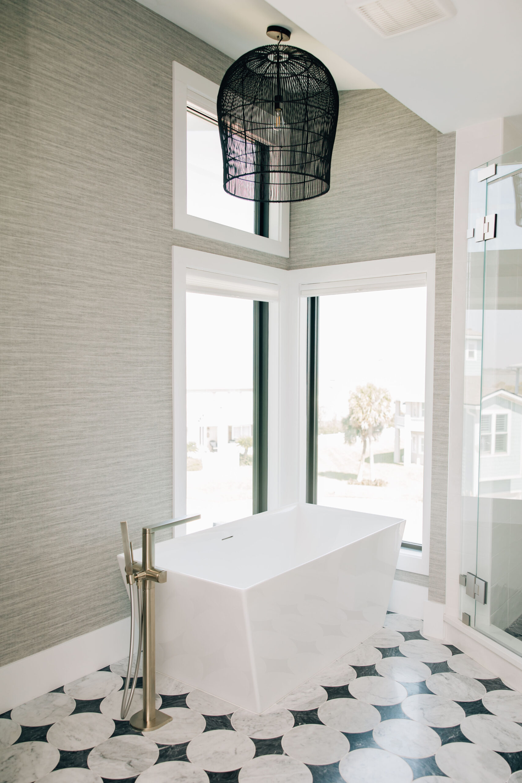 Bathroom with freestanding tub and black-and-white patterned flooring in a luxury Ponte Vedra home.