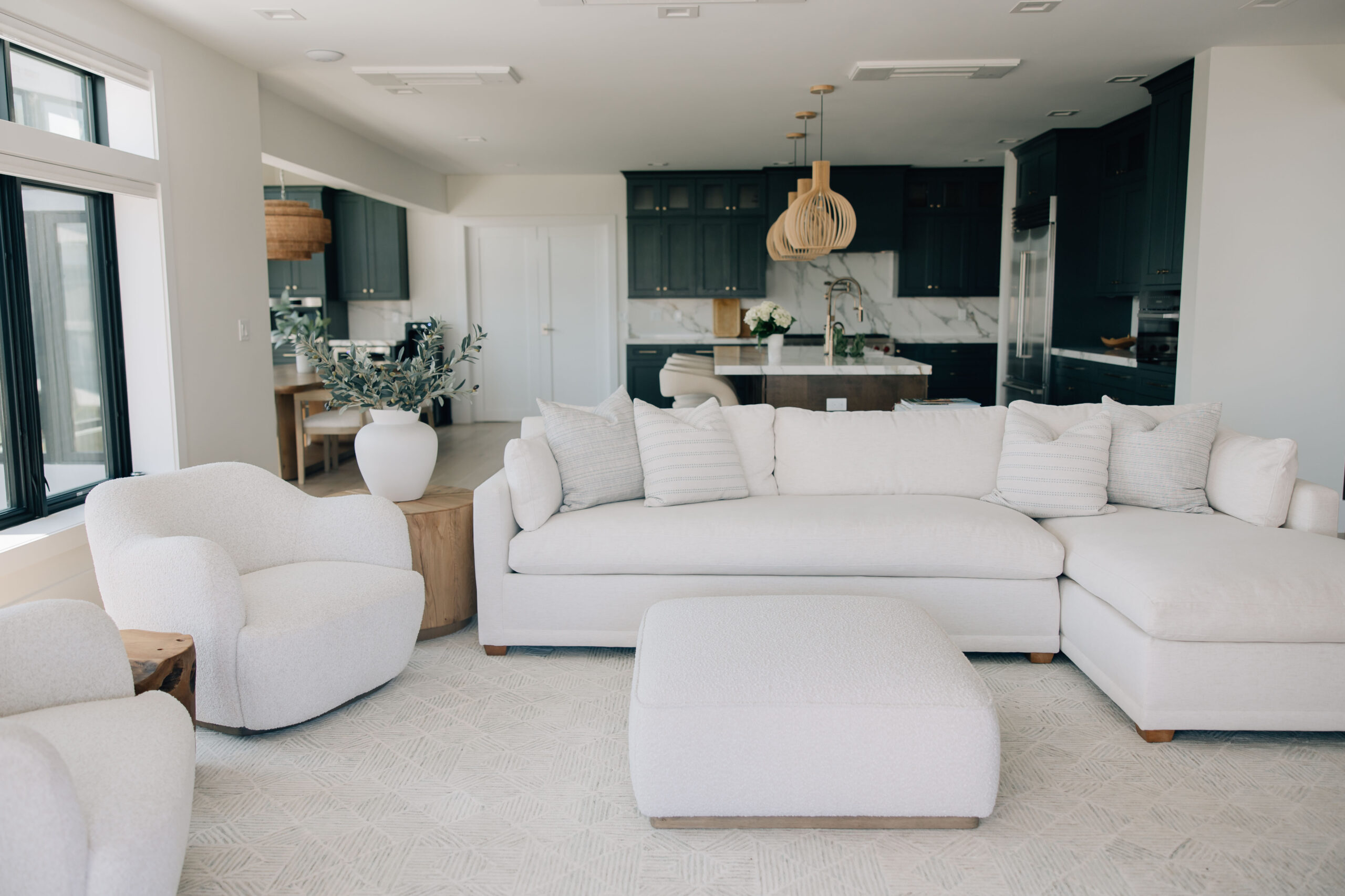 Light-filled living room with neutral furniture and coastal-inspired interior design.