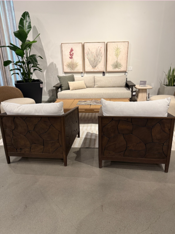 Modern square chairs with dark-toned wood splicing details and crisp white cushions.