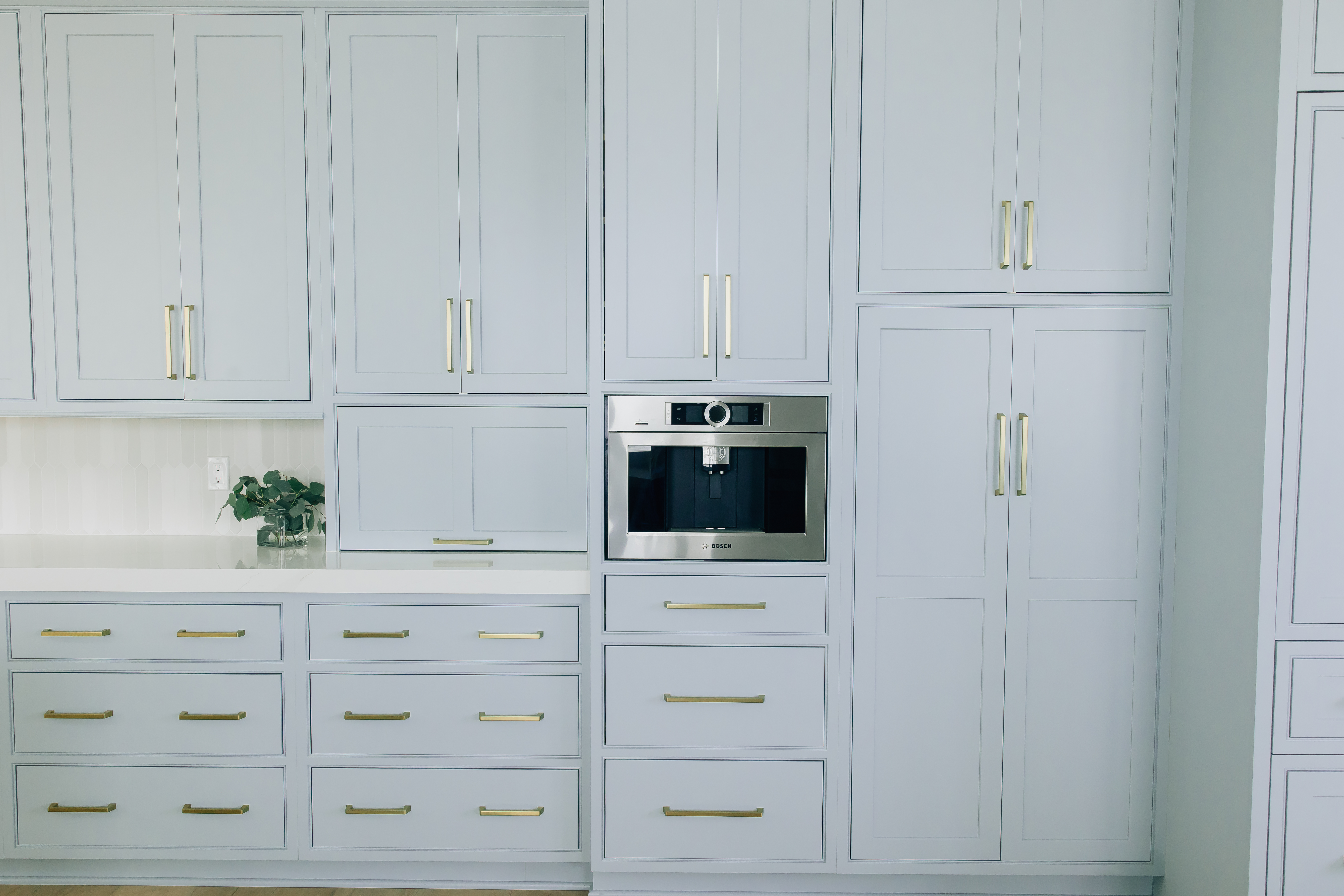 These custom floor to ceiling cabinets help our homeowner stay organized and keep clutter off the countertops.
