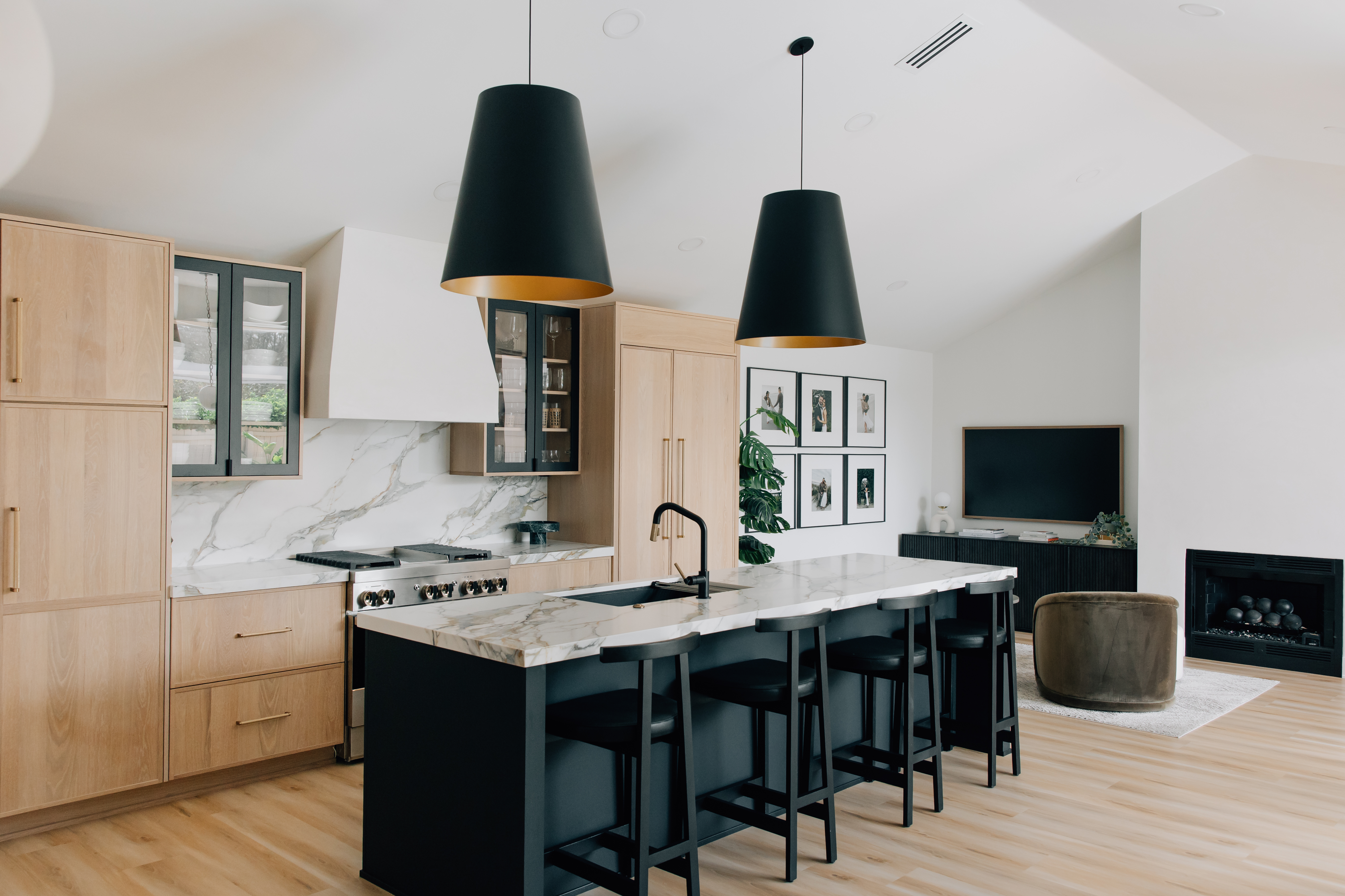 Our homeowner is making a statement with these bold black and gold pendant lights above the kitchen island.