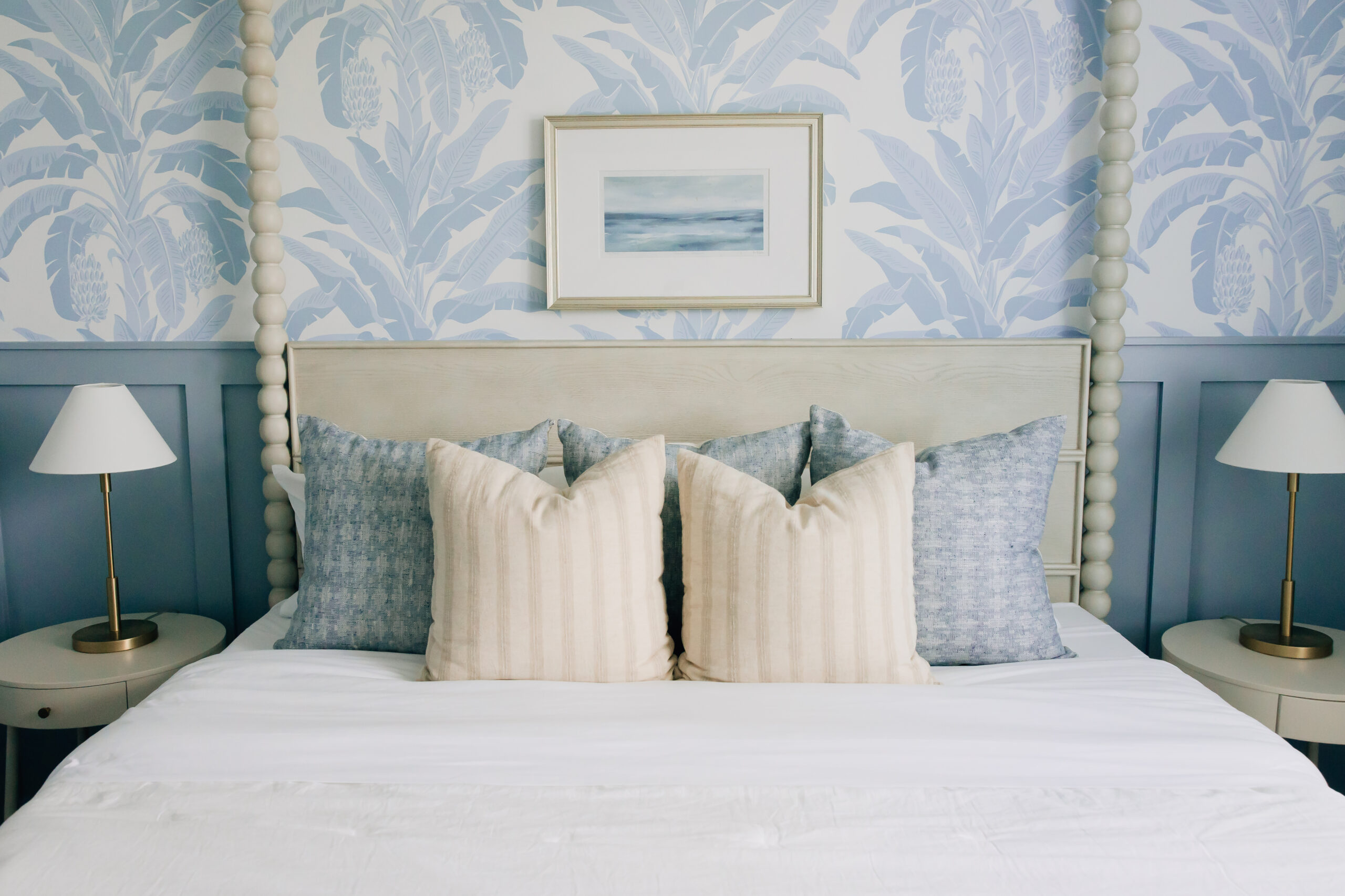 Coastal inspired bedroom with blue accents in various shades balanced with creams, whites, and light browns.
