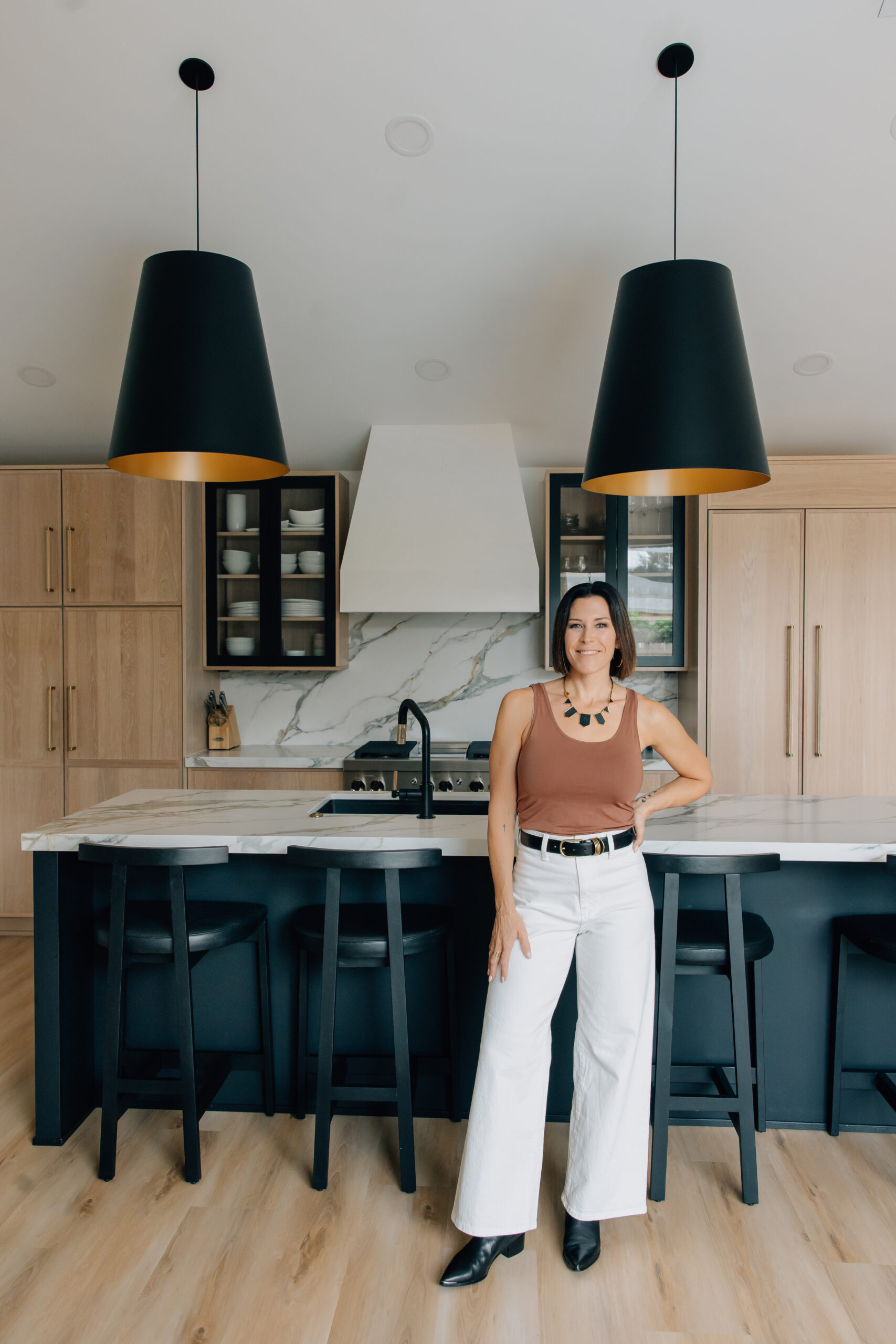 Jessica Woodward of Welcome Home Styling standing in a kitchen featuring 2026 kitchen trends and custom kitchen cabinets.